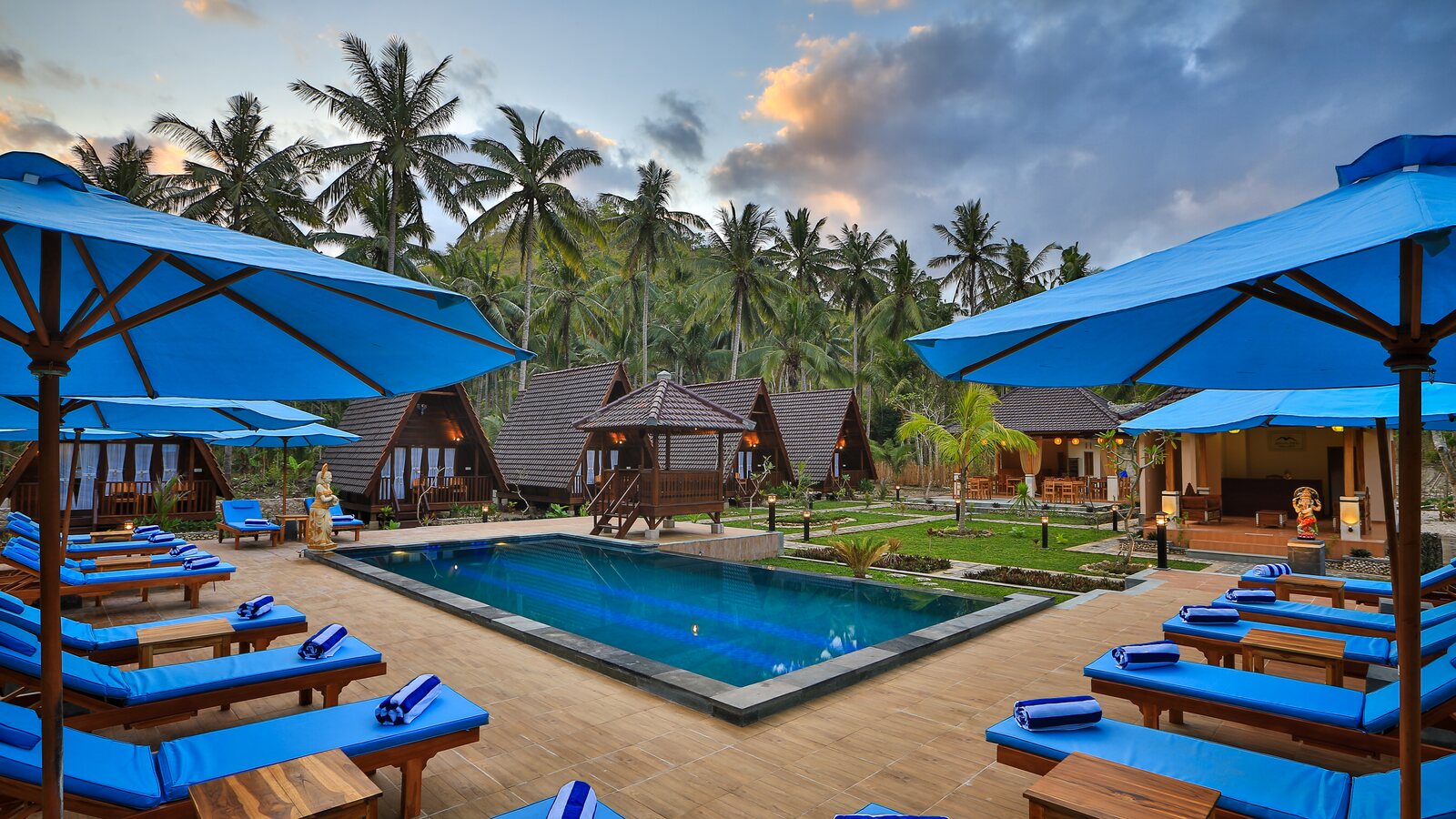 Swimming pool, garden bungalows and palm trees at Mahaloka Valley Resort near Crystal Bay, Nusa Penida